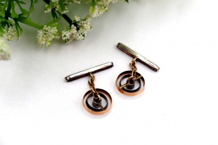 Botões de punho em ouro bicolor com diamantes em talhe brilhante no centro.